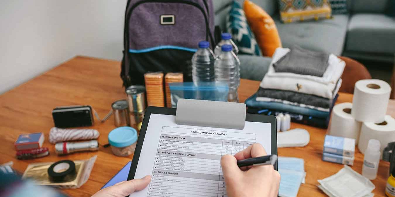 woman-doing-checklist-of-emergency-backpack_sm
